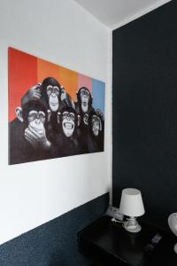 a painting of a group of monkeys on a wall at Sonata City Hotel in Cologne