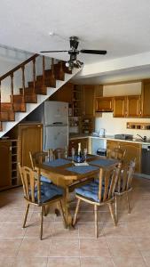 a kitchen with a table and chairs and a staircase at VILLA HOLIDAY in Banjole +17 photos