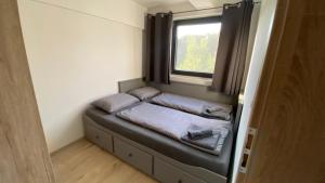 a small bed in a small room with a window at VILLA HOLIDAY in Banjole