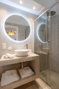 a bathroom with a sink and a shower with a mirror at Nerites residence in Apollonia Sifnos in Apollonia