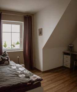 a bedroom with a bed and a window at Pension32 in Burg bei Magdeburg