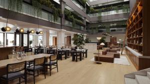 a restaurant with tables and chairs in a building at Metcalfe Hotel Ottawa by Gray Collection in Ottawa