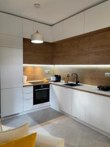 a kitchen with white cabinets and a sink at Nikiti, four seasons house in Nikiti