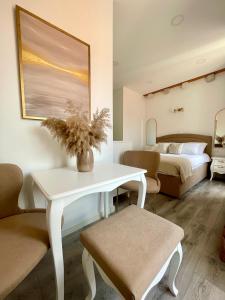 a bedroom with a white table and a bed at Ida Old Town Rooms in Dubrovnik