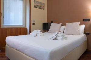 Säng eller sängar i ett rum på Hotel Suite Ares
