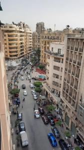 a busy city street filled with cars and buildings at happy life hostel in Cairo
