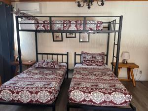 two beds in a room with two bunk beds at Bear Creek Resort in Big Bear Lake