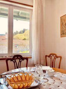 a table with a plate of food and a window at Vila Zorka in Trebinje