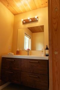 a bathroom with a sink and a mirror at Bear Valley Highlands in Lumby