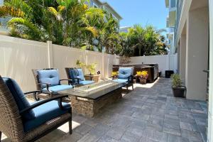 a patio with chairs and a table and a fence at Redington Beach Villas 313 in St. Pete Beach