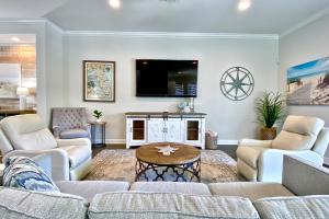 a living room with a couch and a tv at Redington Beach Villas 313 in St. Pete Beach
