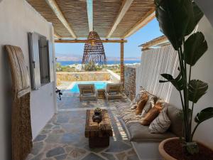 a living room with a couch and a pool at Beachhouse Omega Naxos in Agia Anna Naxos
