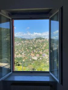 a window with a view of a city at Appartamento Victoria in Camogli