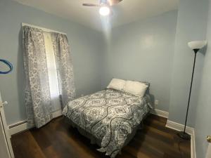 a small bedroom with a bed and a window at Lovely 2 Bedroom Cottage Just Off Orange Lake! in Newburgh