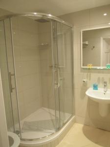 a bathroom with a shower and a sink at Marble Arch Flats in London