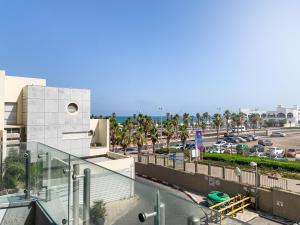 a building with a view of a parking lot at Ashdod on the sea- אשדוד על הים in Ashdod