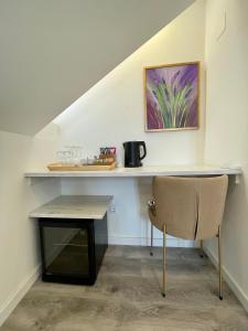 a table and a chair sitting under a staircase at Ida Old Town Rooms 2 in Dubrovnik +3 photos