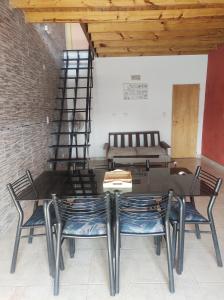a dining room with a table and chairs and a couch at Departamento 1 ambiente zona sur in Rafael Calzada
