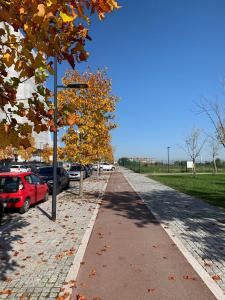 a street with cars parked on the side of the road at Sweet Home in Milano smart district in Milan