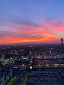 a view of a city at night with a sunset at Sweet Home in Milano smart district in Milan