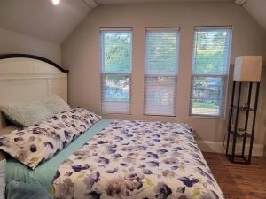 沃尔顿堡滩Dream house with capacity of 23 people的一间卧室，里面有一张床，铺着奶牛图案的被子，还有窗户。