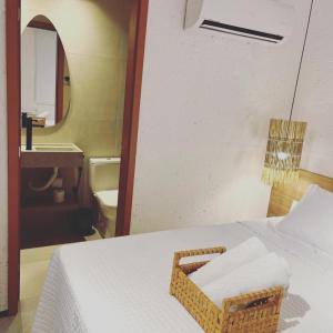 a bathroom with a bed and a sink and a mirror at 7 ESTRELAS PATACHO in Pôrto de Pedras +29 photos