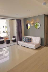 a living room with a white couch in a room at Hermoso Apartasol San Jeronimo in San Jerónimo +17 photos