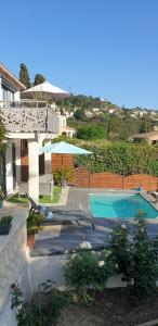 a house with a swimming pool in a yard at STUDIO INDEPENDANT LA TURBIE in La Turbie