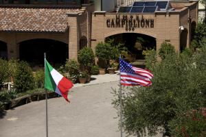 two flags on poles in front of a building at Campiglione Hotel in Bastia Umbra