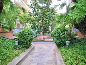 a courtyard with trees and plants in a building at Prati Fiscali Penthouse in Rome
