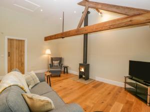 a living room with a couch and a fireplace at The Mill Granary in Bucknell