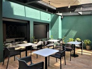 a restaurant with tables and chairs and a projection screen at St. George Hotel in Sofia