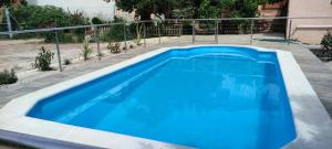 a large blue swimming pool in a yard at Casa Tere in Codo