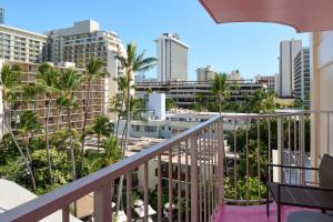 a balcony overlooking a city with palm trees at Ilima Hotel in Honolulu