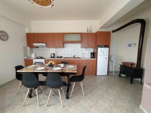 a kitchen with a table and chairs in a room at The South House, Mountain and Sea View in Paránimfoi