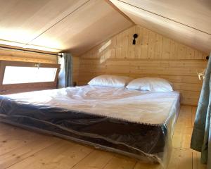 Posteľ alebo postele v izbe v ubytovaní Tiny House LA RUCHETTE