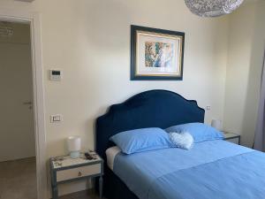 Postel nebo postele na pokoji v ubytování B&B Il Melograno