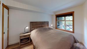 a bedroom with a bed and a television at Lost Lake Lodge by Whistler Premier in Whistler