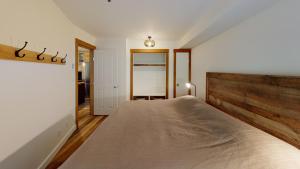 a bedroom with a bed and a dresser at Lost Lake Lodge by Whistler Premier in Whistler