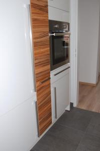 a kitchen with a refrigerator and a stove at Ferienwohnung Stollenwerk am Steinhuder Meer An der Schanze 13 in Steinhude +4 photos