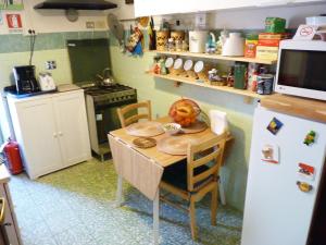 a small kitchen with a table and a refrigerator at Apartment Vatican Vista in Rome