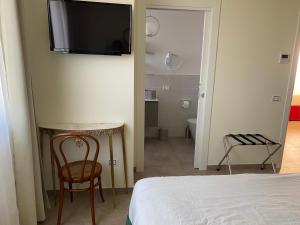Postel nebo postele na pokoji v ubytování B&B Il Melograno
