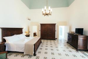Postel nebo postele na pokoji v ubytování Palazzo Scarciglia