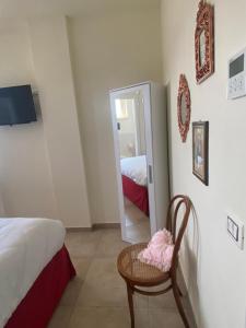 Postel nebo postele na pokoji v ubytování B&B Il Melograno