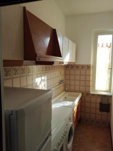 a kitchen with a washing machine and a sink at Casa Graziella in Cecina