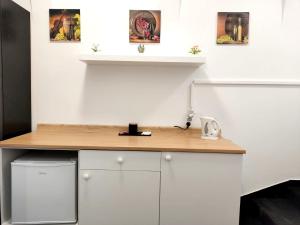 a desk in a room with a white wall at Kozia Store- Stary Rynek in Poznań