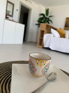a bowl on a napkin with a spoon on a table at Samarkanda Apartamento- Suite con espectacular vista panorámica in Las Negras