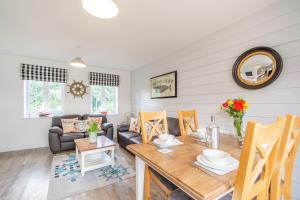 a living room with a table and a couch at Lilipad Cottage in Reighton +14 photos