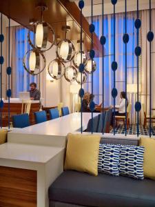 a dining room with a table and people sitting at a table at Sonesta ES Suites Houston Galleria in Houston