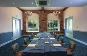 a conference room with a long table and chairs at Blarney Woollen Mills Hotel - BW Signature Collection in Blarney